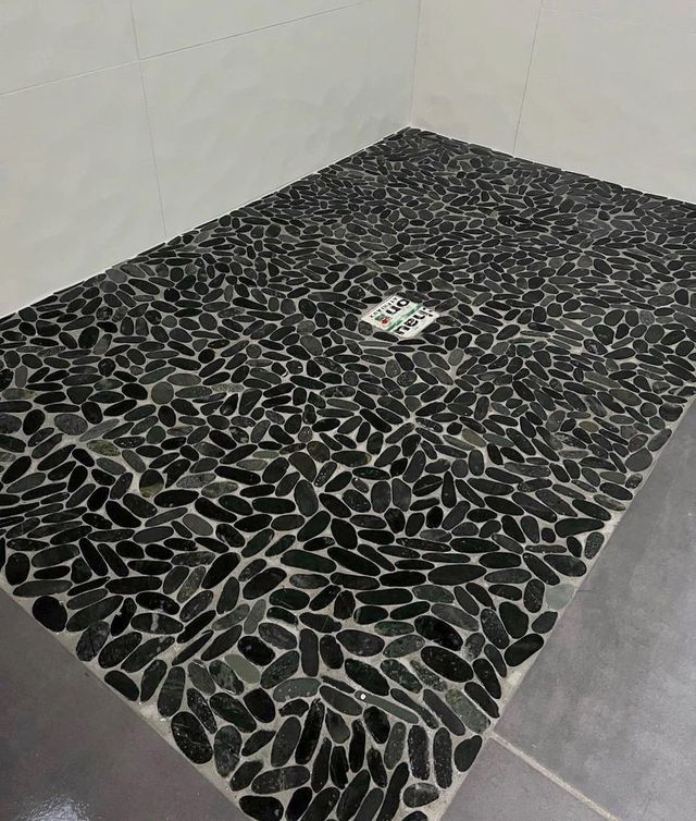 Douche à l’italienne, receveur en galets noirs